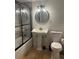 Bathroom featuring pedestal sink, toilet, and tiled tub/shower with black-framed glass doors at 2784 Williamsburg Way, Decatur, GA 30034