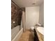 Well-lit bathroom featuring tile shower, a granite countertop, and a toilet at 2784 Williamsburg Way, Decatur, GA 30034