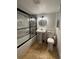 Bathroom featuring pedestal sink, toilet, and tiled tub/shower with glass doors at 2784 Williamsburg Way, Decatur, GA 30034