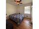 Cozy bedroom with a patterned comforter on the bed, a window and wood flooring at 2784 Williamsburg Way, Decatur, GA 30034