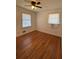 Bright bedroom featuring hardwood floors, two windows, and baseboard heating at 2784 Williamsburg Way, Decatur, GA 30034