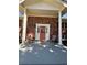 Charming front porch with brick facade, decorative columns, and outdoor seating at 2784 Williamsburg Way, Decatur, GA 30034