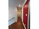 The hardwood hallway offers neutral walls and a bold red accent wall at 2784 Williamsburg Way, Decatur, GA 30034