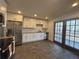 Updated kitchen with stainless steel appliances, white cabinets, granite counters, and tiled floor at 2784 Williamsburg Way, Decatur, GA 30034
