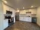 Well-lit kitchen featuring stainless steel appliances, bright white cabinetry, and tiled flooring at 2784 Williamsburg Way, Decatur, GA 30034