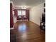 Bright living room featuring hardwood floors, a vibrant red accent wall, and bar seating at 2784 Williamsburg Way, Decatur, GA 30034