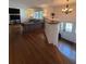 Open-concept living room with hardwood floors and updated lighting at 2784 Williamsburg Way, Decatur, GA 30034
