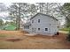 Back exterior showcasing a two-story home with neutral siding and well-maintained yard at 3201 Palomino Dr, Powder Springs, GA 30127