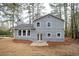 View of the home's backyard featuring a patio and mature trees at 3201 Palomino Dr, Powder Springs, GA 30127