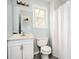 Bathroom with a vanity, toilet, framed mirror, and shower with curtain at 3201 Palomino Dr, Powder Springs, GA 30127
