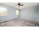 Spacious bedroom with neutral carpet, ample natural light from two windows, and ceiling fan at 3201 Palomino Dr, Powder Springs, GA 30127