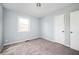 A bright bedroom has neutral carpet, light blue walls and a white closet door at 3201 Palomino Dr, Powder Springs, GA 30127