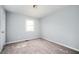 Bedroom featuring neutral carpet, light blue walls, and a single window at 3201 Palomino Dr, Powder Springs, GA 30127