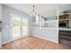 Dining area with french doors, chandelier, and seamless flow into living room with fireplace at 3201 Palomino Dr, Powder Springs, GA 30127