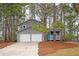 Charming two-story home featuring a blue front door and a two-car garage at 3201 Palomino Dr, Powder Springs, GA 30127