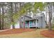 Charming two-story home featuring a blue front door and a two-car garage at 3201 Palomino Dr, Powder Springs, GA 30127