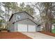 Side exterior of the home with a two-car garage and well maintained lawn at 3201 Palomino Dr, Powder Springs, GA 30127