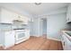Eat-in kitchen featuring white appliances and bright tile flooring at 3201 Palomino Dr, Powder Springs, GA 30127