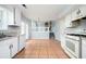 Bright kitchen featuring white cabinets, stainless appliances, and open floorplan at 3201 Palomino Dr, Powder Springs, GA 30127