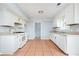Bright eat-in kitchen featuring white appliances and tile flooring at 3201 Palomino Dr, Powder Springs, GA 30127