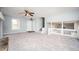 Spacious living room with a stone fireplace, large windows, and new carpeting at 3201 Palomino Dr, Powder Springs, GA 30127