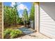 The backyard is filled with greenery, with a brick retaining wall and a path leading out of sight at 235 Briscoe Way # 7, Alpharetta, GA 30009