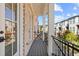 Cozy balcony with brick walls, white columns, iron railings and a view of the neighborhood at 235 Briscoe Way # 7, Alpharetta, GA 30009