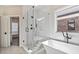 Modern bathroom featuring a frameless shower, soaking tub, and black fixtures bringing a touch of elegance at 235 Briscoe Way # 7, Alpharetta, GA 30009