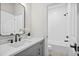 Bright bathroom features a gray vanity, sleek black fixtures, and a shower/tub combo with white subway tile at 235 Briscoe Way # 7, Alpharetta, GA 30009