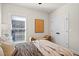 Bright bedroom featuring a window with blinds, stylish decor, and a comfortable bed with soft pillows at 235 Briscoe Way # 7, Alpharetta, GA 30009