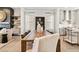 Neutral open-plan dining area with fireplace, floating shelves, and view into kitchen at 235 Briscoe Way # 7, Alpharetta, GA 30009