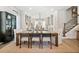 An open dining room features a long wood table, neutral tones, and views into kitchen at 235 Briscoe Way # 7, Alpharetta, GA 30009