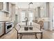 Gourmet kitchen boasts a large island, ample counter space, and modern stainless steel appliances at 235 Briscoe Way # 7, Alpharetta, GA 30009
