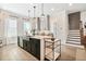 Bright open kitchen featuring a large island with seating, pendant lighting and modern finishes at 235 Briscoe Way # 7, Alpharetta, GA 30009