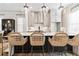 Bright kitchen island with bar stool seating, pendant lights, and modern appliances at 235 Briscoe Way # 7, Alpharetta, GA 30009
