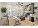 Cozy living room featuring a fireplace, French doors, hardwood floors, and comfortable neutral-toned furniture at 235 Briscoe Way # 7, Alpharetta, GA 30009