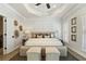 This bright main bedroom features a tray ceiling, neutral walls and flooring, with plush furnishings creating a peaceful retreat at 235 Briscoe Way # 7, Alpharetta, GA 30009