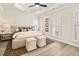 Bright main bedroom features a tray ceiling, neutral walls and flooring, and plush furnishings creating a peaceful retreat at 235 Briscoe Way # 7, Alpharetta, GA 30009