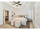 Bright main bedroom features a tray ceiling, neutral walls and flooring, and plush furnishings creating a peaceful retreat at 235 Briscoe Way # 7, Alpharetta, GA 30009