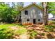 A view of the backyard of the home, showing a walkout basement and mature landscaping at 2949 Pearl St, East Point, GA 30344