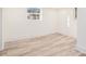 Finished basement featuring durable, light wood-look flooring and natural light from above-ground window at 2949 Pearl St, East Point, GA 30344