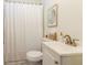 Cozy bathroom featuring a white sink, shower with white curtain, and neutral wall art at 2949 Pearl St, East Point, GA 30344