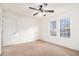 Spacious bedroom with a ceiling fan and ample natural light from multiple windows at 2949 Pearl St, East Point, GA 30344