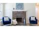 Close-up of fireplace with decorative brickwork and stylish seating area at 2949 Pearl St, East Point, GA 30344