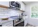 Contemporary kitchen showcasing stainless steel appliances and a subway tile backsplash at 2949 Pearl St, East Point, GA 30344