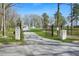 Long driveway leading to a charming home, framed by a gated entrance at 4900 College St, Union City, GA 30291