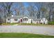 Charming white-painted brick home with a manicured lawn and a gravel driveway at 4900 College St, Union City, GA 30291