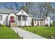 Charming white painted brick home featuring manicured landscaping and a lovely front yard at 4900 College St, Union City, GA 30291