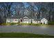 Charming white-painted brick home with a manicured lawn and a gravel driveway at 4900 College St, Union City, GA 30291