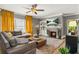 Inviting living room featuring a brick fireplace, a soft rug, and comfortable seating at 4900 College St, Union City, GA 30291